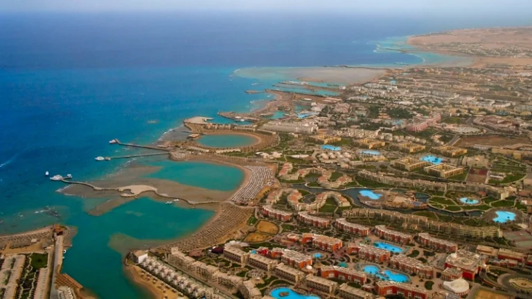"A scenic view of Hurghada's crystal-clear waters and sandy beaches with boats floating on the Red Sea."