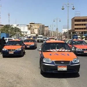 A vibrant bazaar in Hurghada with colorful stalls and a taxi parked nearby